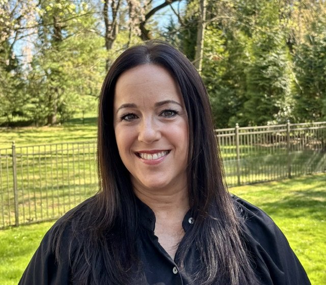 Mel, certified life and wellness coach, smiling outdoors