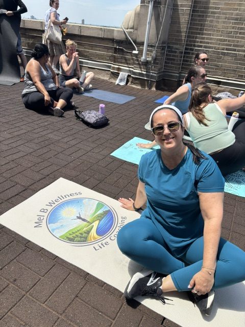 A rooftop session with participants on mats